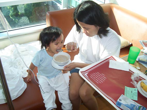 Tash being fed by yaya Jen