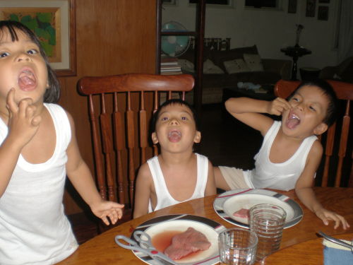 3 kids enjoying a raw beef dinner